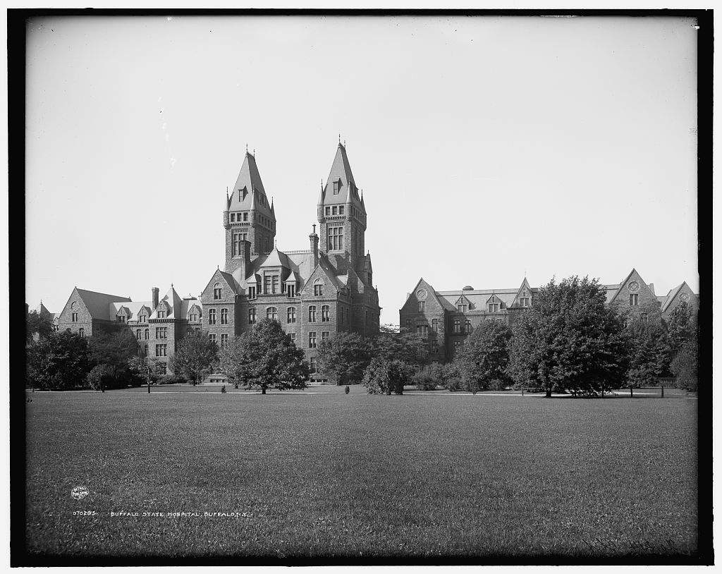 View of the Richardson complex fronted by a large law, with the twin towers of the Administration building in the center